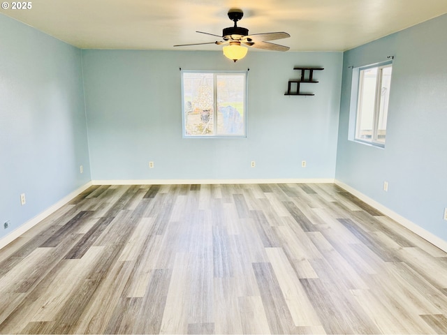 551 NW T St, Winston, OR 97496 - empty room with wood finished floors, a ceiling fan, and baseboards