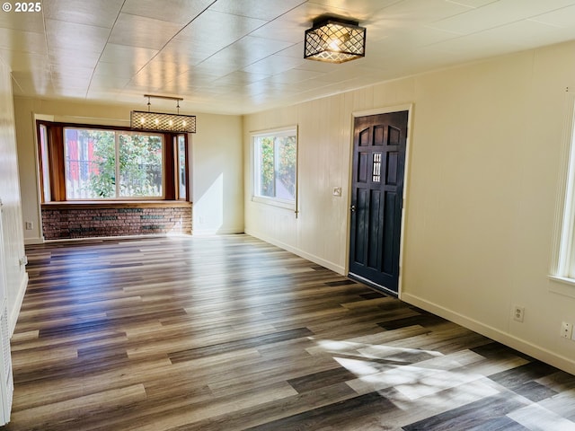 551 NW T St, Winston, OR 97496 - interior space with rail lighting, baseboards, wood finished floors, and brick wall