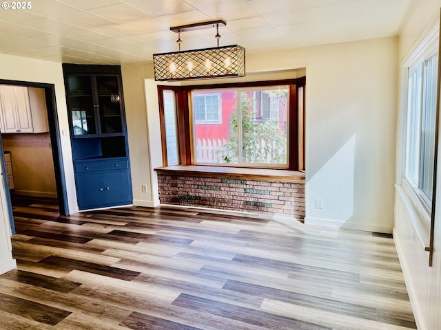 551 NW T St, Winston, OR 97496 - unfurnished dining area featuring baseboards and wood finished floors