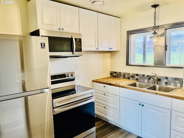 551 NW T St, Winston, OR 97496 - kitchen featuring butcher block countertops, white cabinetry, stainless steel appliances, and a sink