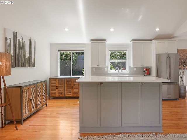 1720 Kilkenny Dr, Lake Oswego, OR 97034 - kitchen featuring high end fridge, light wood-style floors, light countertops, a center island, and white cabinets