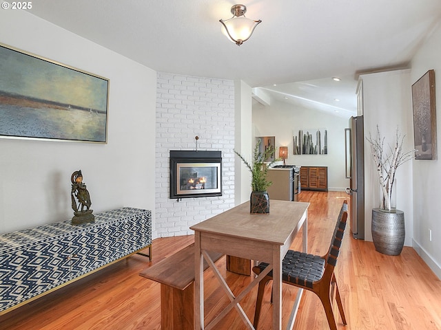 1720 Kilkenny Dr, Lake Oswego, OR 97034 - dining area featuring light wood-style flooring, lofted ceiling, and a brick fireplace