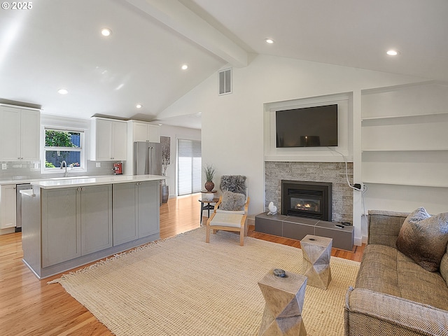 1720 Kilkenny Dr, Lake Oswego, OR 97034 - living area with a tiled fireplace, beam ceiling, light wood-style floors, recessed lighting, and high vaulted ceiling