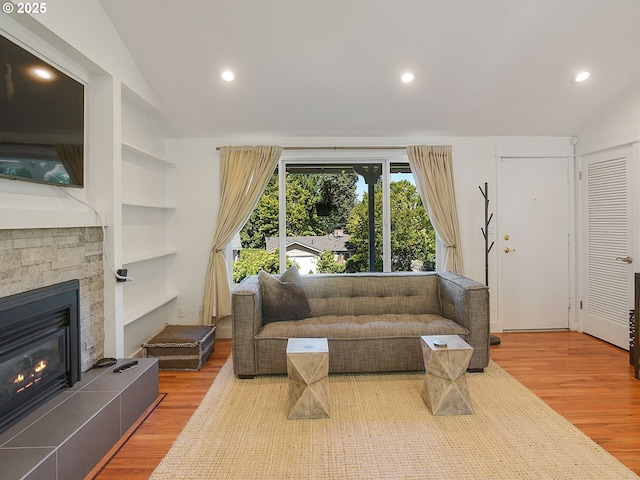 1720 Kilkenny Dr, Lake Oswego, OR 97034 - living area featuring vaulted ceiling, wood finished floors, recessed lighting, a stone fireplace, and built in features