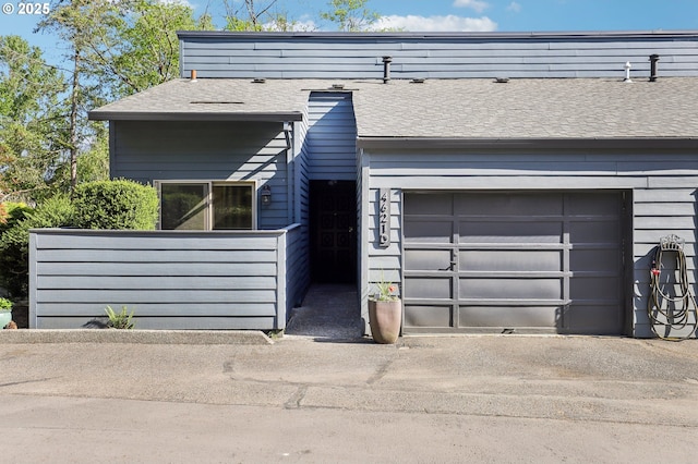4621 SW Caldew St Unit D, Portland, OR 97219 - view of front of house featuring roof with shingles, driveway, and a garage