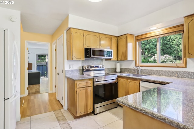 4621 SW Caldew St Unit D, Portland, OR 97219 - kitchen featuring appliances with stainless steel finishes, plenty of natural light, and light tile patterned floors