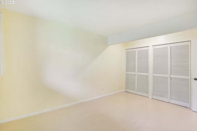 4621 SW Caldew St Unit D, Portland, OR 97219 - unfurnished bedroom with baseboards and two closets