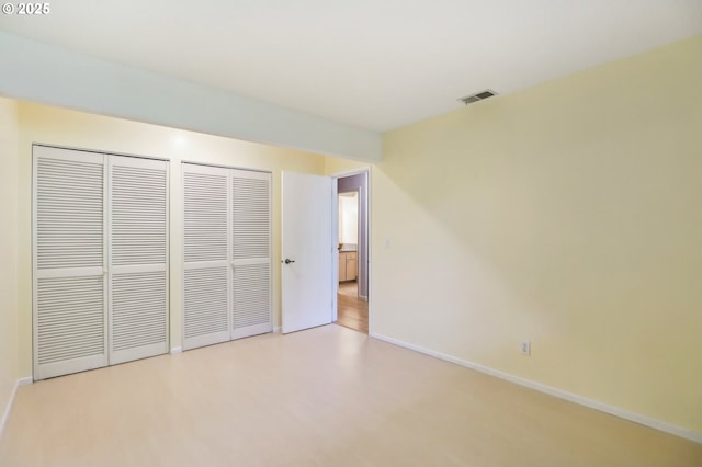 4621 SW Caldew St Unit D, Portland, OR 97219 - unfurnished bedroom featuring baseboards and two closets