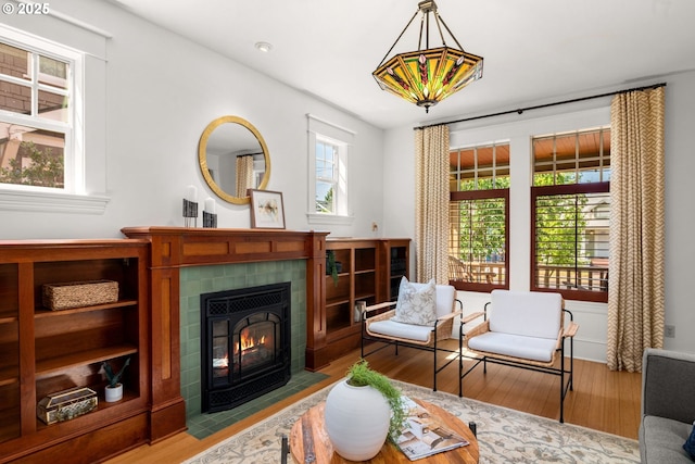 1620 NE Going St, Portland, OR 97211 - living room featuring plenty of natural light, wood finished floors, a tiled fireplace, and recessed lighting