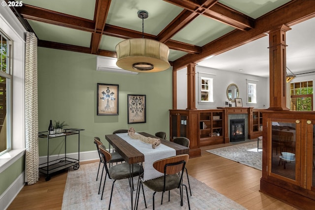 1620 NE Going St, Portland, OR 97211 - dining area featuring decorative columns, wood finished floors, beamed ceiling, coffered ceiling, and a fireplace with flush hearth