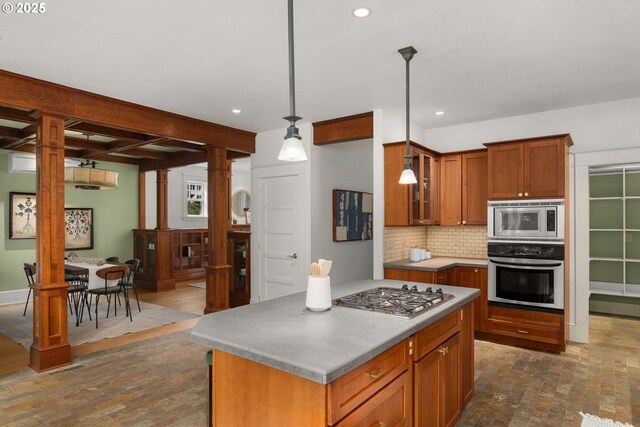 1620 NE Going St, Portland, OR 97211 - kitchen with appliances with stainless steel finishes, decorative backsplash, recessed lighting, glass insert cabinets, and decorative light fixtures