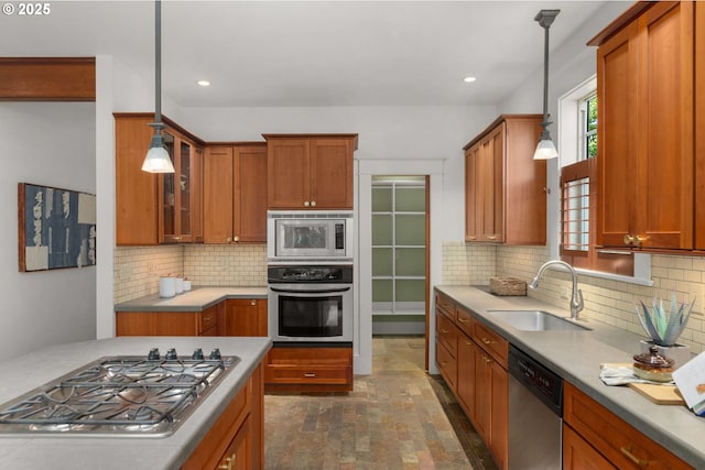 1620 NE Going St, Portland, OR 97211 - kitchen with stainless steel appliances, brown cabinets, glass insert cabinets, decorative backsplash, and hanging light fixtures
