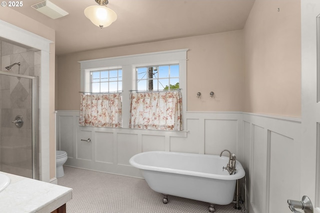 1620 NE Going St, Portland, OR 97211 - full bathroom with a decorative wall, a soaking tub, a wainscoted wall, a shower stall, and vanity