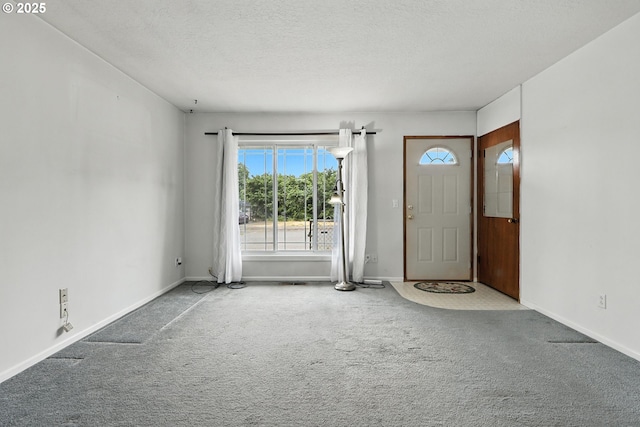 12130 SE Reedway St, Portland, OR 97266 - carpeted foyer entrance featuring baseboards and a textured ceiling
