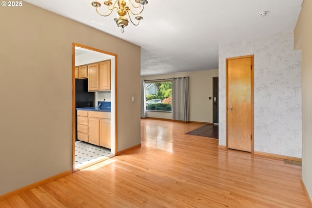 3602 NE 134th Ave, Portland, OR 97230 - unfurnished dining area with light wood finished floors, a chandelier, and wallpapered walls