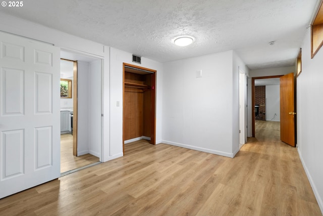 3602 NE 134th Ave, Portland, OR 97230 - unfurnished bedroom with light wood-style floors, a textured ceiling, and a closet