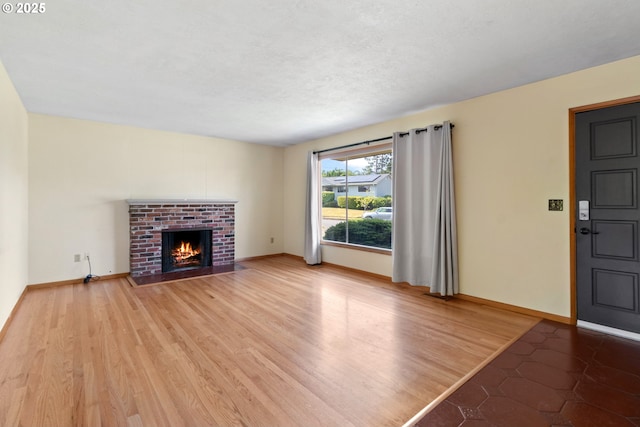 3602 NE 134th Ave, Portland, OR 97230 - unfurnished living room featuring a brick fireplace and wood finished floors