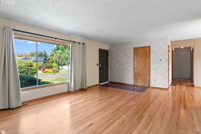 3602 NE 134th Ave, Portland, OR 97230 - unfurnished living room with light wood finished floors and wallpapered walls