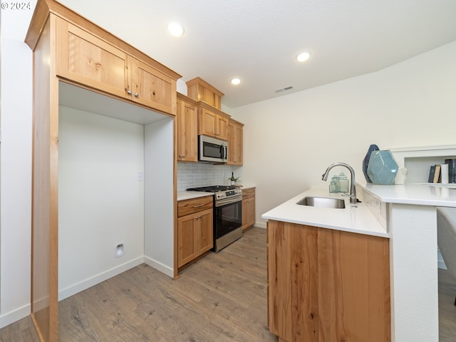 2366 Kingwood St, Forest Grove, OR 97116 - kitchen with tasteful backsplash, visible vents, light wood-style flooring, stainless steel appliances, and a sink