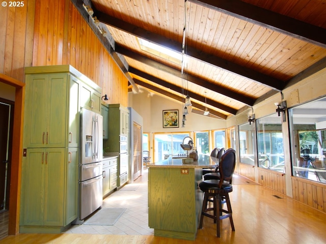 3062 S Tenmile, Lakeside, OR 97449 - kitchen with green cabinetry, stainless steel refrigerator with ice dispenser, wooden walls, a kitchen island, and wood ceiling