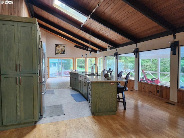 3062 S Tenmile, Lakeside, OR 97449 - kitchen with green cabinetry, wooden ceiling with exposed beams, a sink, light wood-style floors, and high vaulted ceiling