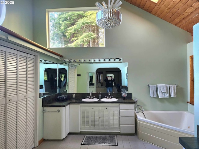 3062 S Tenmile, Lakeside, OR 97449 - bathroom featuring vanity, a garden tub, wooden ceiling, a closet, and a chandelier