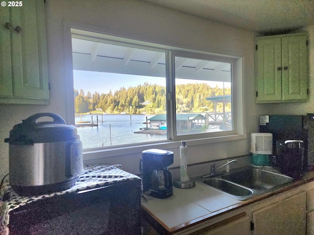 3062 S Tenmile, Lakeside, OR 97449 - kitchen featuring a sink and a view of trees