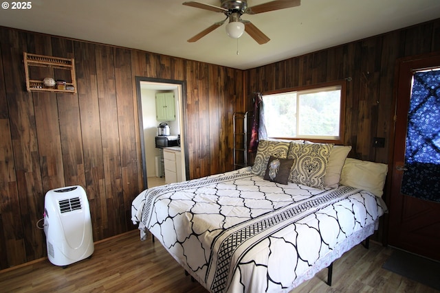3062 S Tenmile, Lakeside, OR 97449 - bedroom with wooden walls, wood finished floors, and a ceiling fan