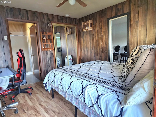 3062 S Tenmile, Lakeside, OR 97449 - bedroom with wooden walls, a closet, wood finished floors, and a ceiling fan