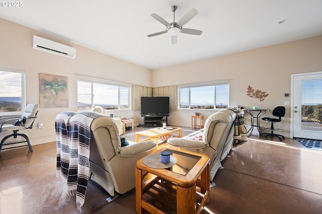 living room featuring concrete floors, plenty of natural light, ceiling fan, and a wall mounted AC