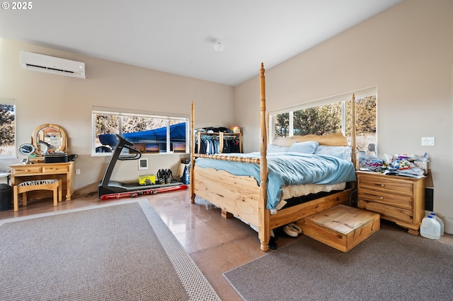 bedroom featuring concrete floors and a wall mounted air conditioner