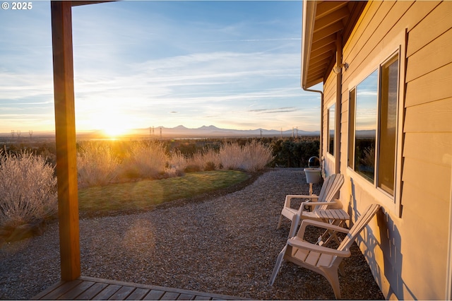 yard at dusk featuring a mountain view