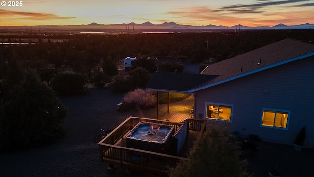 aerial view at dusk featuring a mountain view