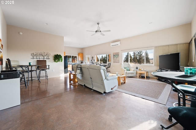 living room with ceiling fan, concrete floors, and a wall mounted AC