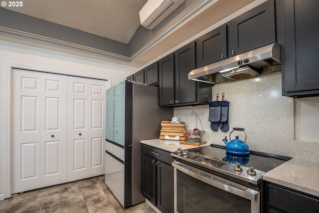 kitchen featuring light stone counters, tasteful backsplash, appliances with stainless steel finishes, under cabinet range hood, and dark cabinets
