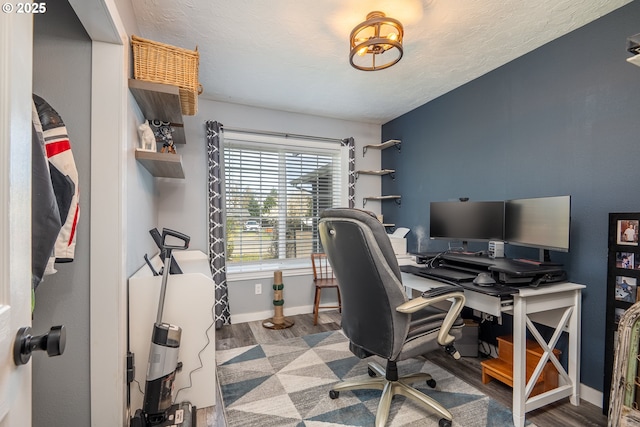 office featuring baseboards, wood finished floors, and a textured ceiling