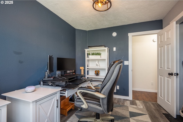 office space featuring baseboards, a textured ceiling, and wood finished floors