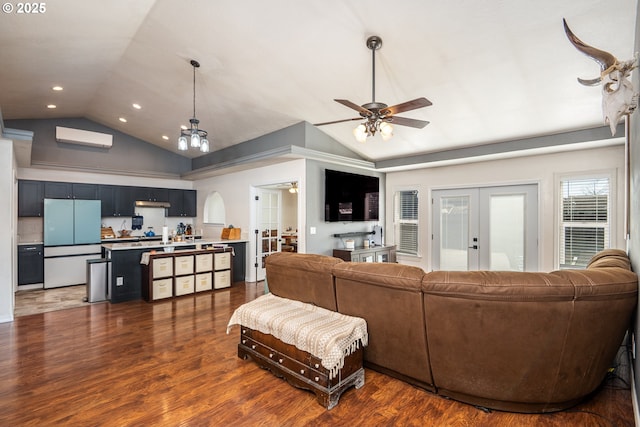 living area with ceiling fan, wood finished floors, recessed lighting, lofted ceiling, and french doors