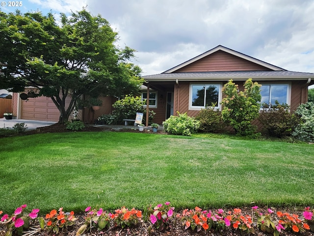 288 N Dorcas Dr, Keizer, OR 97303 - view of green lawn with driveway and an attached garage