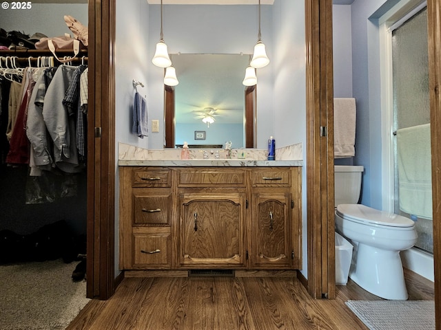 288 N Dorcas Dr, Keizer, OR 97303 - bathroom with wood finished floors, vanity, ceiling fan, and a walk in closet
