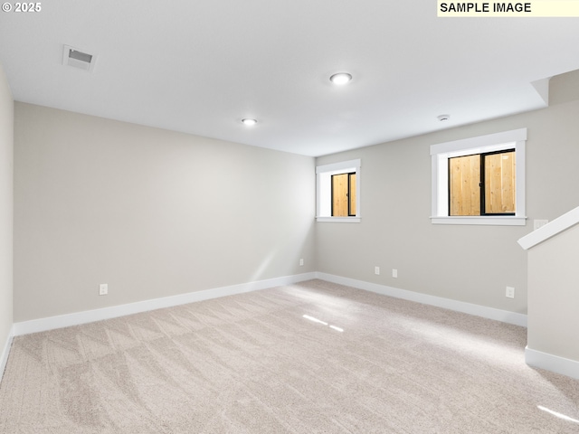 spare room featuring light colored carpet