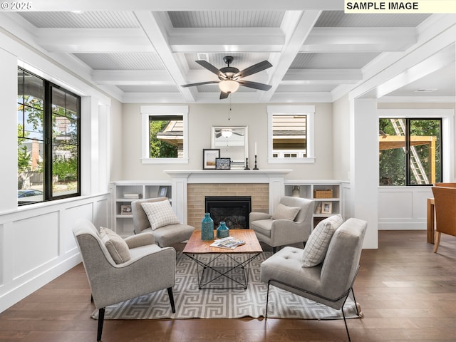 living room featuring a fireplace, dark hardwood / wood-style floors, ceiling fan, and ornamental molding