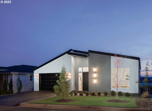 view of front of house with a yard and a garage