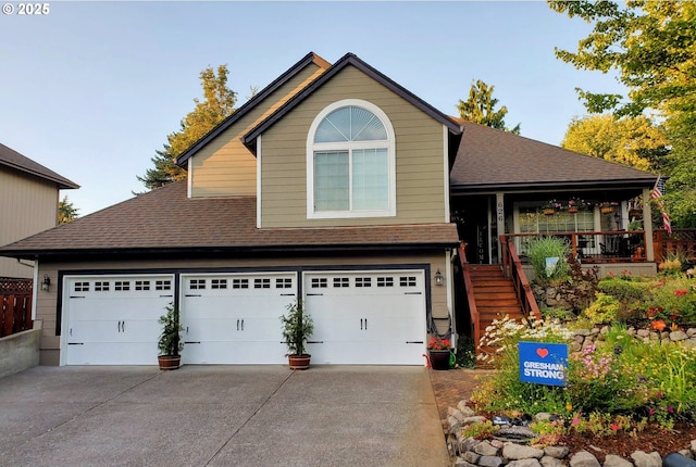 view of front of home with a porch, a garage, driveway, stairway, and roof with shingles