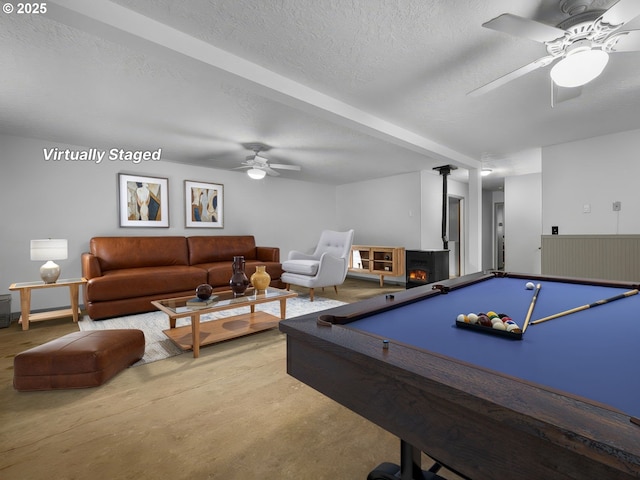 17222 SE Tickle Creek Rd, Boring, OR 97009 - recreation room with a wood stove, ceiling fan, a textured ceiling, and concrete floors