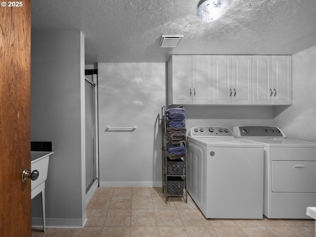 17222 SE Tickle Creek Rd, Boring, OR 97009 - laundry area with washing machine and clothes dryer, cabinet space, baseboards, and a textured ceiling