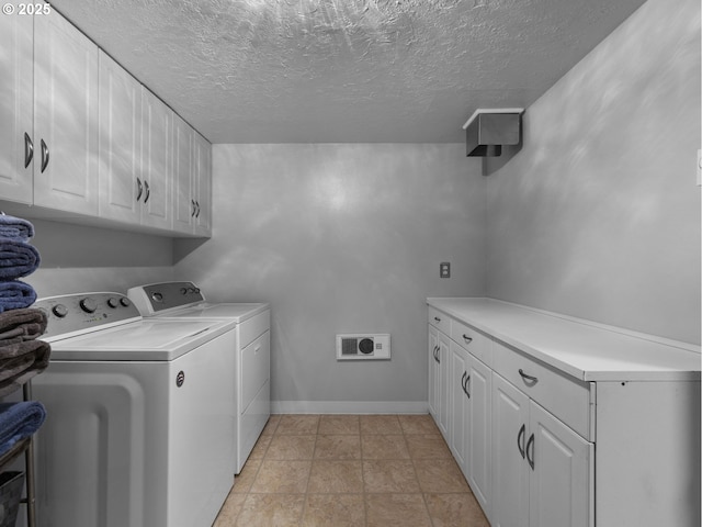 17222 SE Tickle Creek Rd, Boring, OR 97009 - laundry room with cabinet space, washer and clothes dryer, a textured ceiling, and baseboards