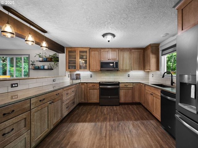 17222 SE Tickle Creek Rd, Boring, OR 97009 - kitchen featuring appliances with stainless steel finishes, a sink, dark wood-style flooring, brown cabinets, and backsplash