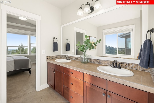 full bath featuring plenty of natural light, decorative backsplash, and double vanity