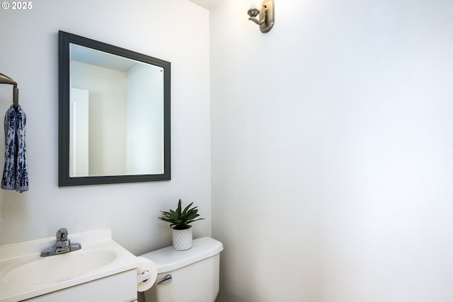 half bathroom featuring toilet and vanity